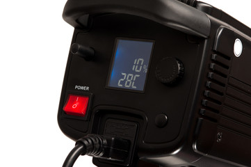 Close-up - side view - the back panel of a professional black studio illuminator with power button. Studio equipment concept