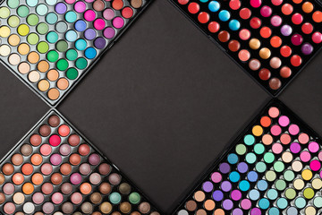 Colorful make-up eyeshadow palettes as a cosmetic background