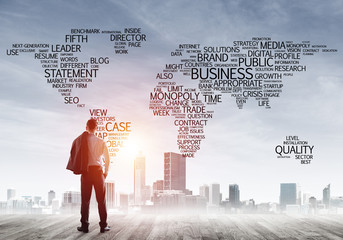 Motivation and inspiration concept with modern cityscape and businessman observing it
