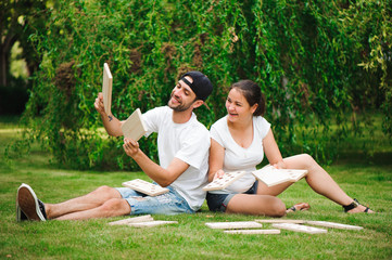 Young man and woman playing giant dominoes in the Park on the grass.