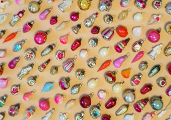 Many colorful new year toys lying on color background, top view, flat lay. Creative Christmas...
