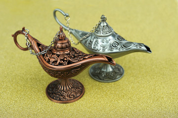 Old style arabian copper oil lamps on gold background.