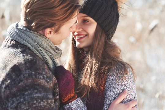 Cheerful young couple having fun in winter park