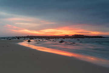 Sunrise at Pretty Beach on the South Coast of New South Wales. Bright colours, sand and surf in Australia.