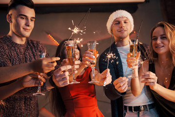 A photo featuring a group of friends who have fun with snowmen and champagne. Happy New Year. Close up.