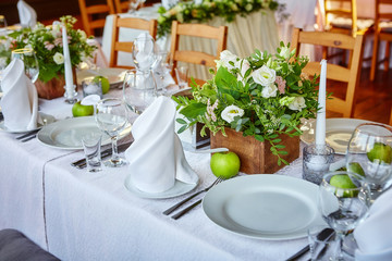 Simple and elegant table for a festive or wedding event, decorated in green and white