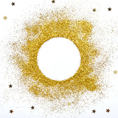 Golden glitter and stars on white background . Round frame.