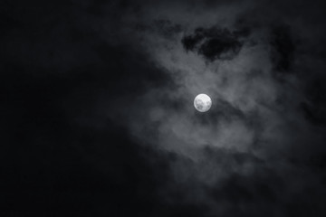 Naklejka na ściany i meble Full moon with dark clouds in the night sky