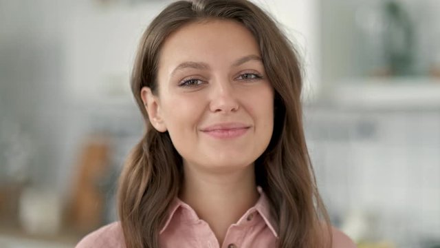 close up independent business woman portrait of attractive brunette executive smiling friendly looking at camera wearing suit