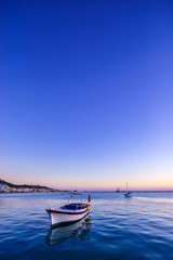 Naklejka premium wooden fishing boat moored in port of Zante town.