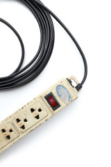 Old and unsafe power strip with illuminated switch isolated on white background