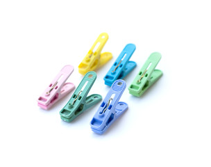 Pile of colorful clothespins isolated on white background
