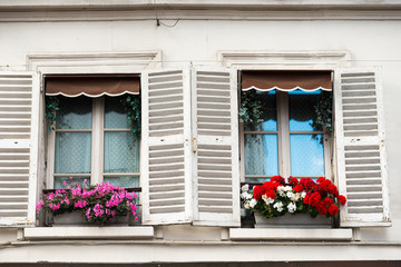 Fototapeta na wymiar Paris windows with flowers on Montmartre street