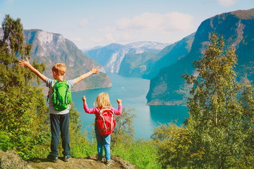 Fototapeta na wymiar happy little boy and girl travel in nature, family hiking