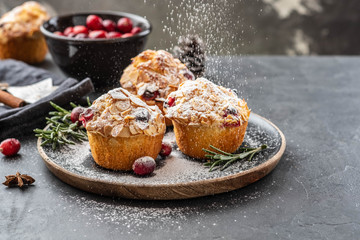 Muffins, cakes with cranberry, rosemary and almond nuts. Christmas decoration. Copy space.