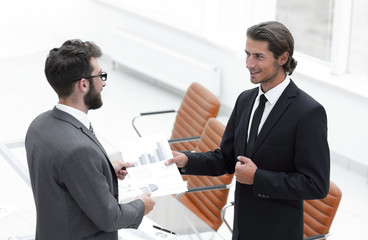 two businessmen talking in the office.