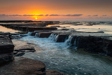 Sunrise at Austinmer Beach, Australia. Morning glow on the South Coast of New South Wales.