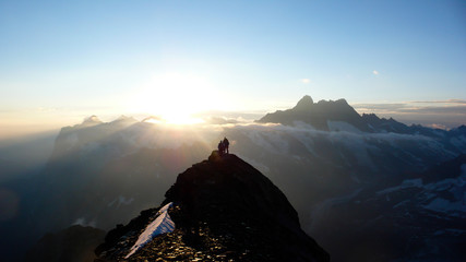several mountain climbers on the famous Mittellegi Ridge on Eiger mountain in the Alps of...