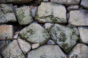 Small stones wedged between larger stones in Japanese castle wall