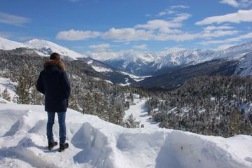 Fototapeta na wymiar Man watching Swiss National Park in wintertime, Switzerland