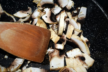 Sliced champignons in a pan before frying.
