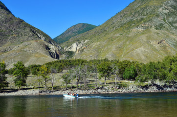 Mountain Altai. Crossing the Chulyshman river by motor boat