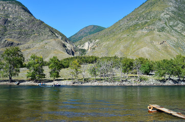 Mountain Altai. Crossing the Chulyshman river by motor boat