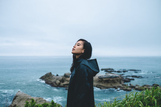 Portrait of young woman wearing raincoat