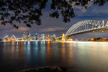 Sydney cityscape with reflections off Sydney Harbour. Night view off Sydney city.