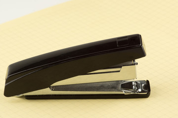 stapler for stapling papers on a table
