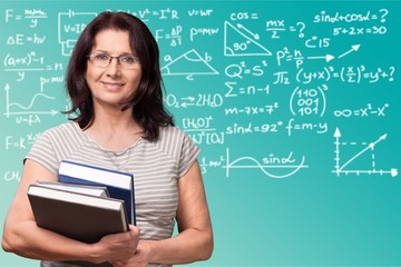 Mature woman teacher with books on background