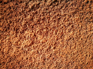 Orange decorative plaster on the wall as a background