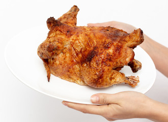 Fresh grilled chicken in hands isolated on white background