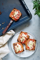 Ruddy toast with baked tomatoes, cheese and herbs. Morning breakfast. Crisp, Grilled, baked toast.