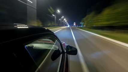 Obraz premium Drivelapse from top Side of Car moving on a night highway timelapse hyperlapse