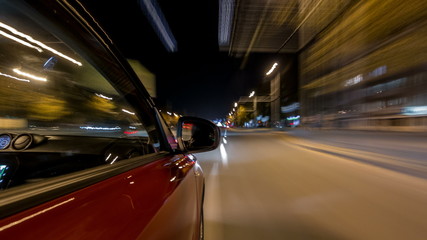 Drivelapse from side of car moving on a night avenue in city timelapse hyperlapse