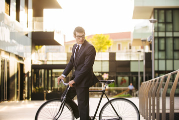 Fototapeta na wymiar Businessman cycling outdoors