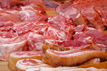 Bacon, pork, lard is sold at local farmers market. Fresh raw meat on counter.