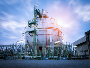 Gas storage spheres tank in oil refinery plant on sky sunrise