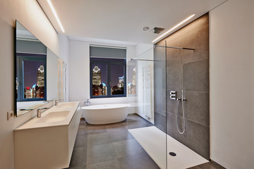 Bathtub in corian, Faucet and shower in tiled bathroom