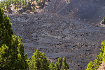 Black frozen lava of the volcano close up