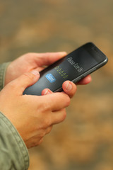 Close up of woman's hands with smartphone and please rate us lettering