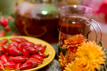 autumn tea with rosehip in the garden on the table
