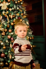 Happy family mother and son with sparkler near a Christmas tree