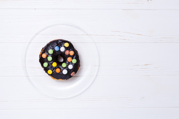 donut in sugar glaze on transparent plate