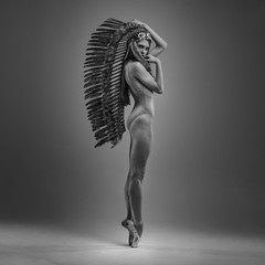 classic ballet dancer with indian feathers plume dancing with elegance