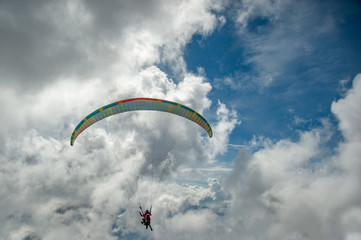 Paraglider is flying in the clouds