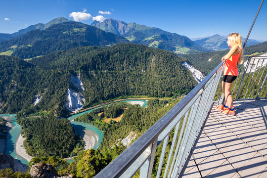 Young girl looks over the river from Il Spir terrace, Rhine Gorge (Ruinaulta), Flims, District of Imboden, Canton of Grisons (Graubunden)