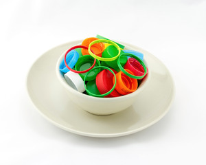 Recycle  plastic caps waste in bowl and plate isolated on white background