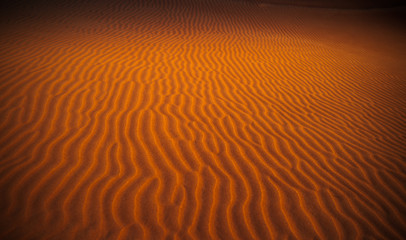 Structure on desert soil at sunset